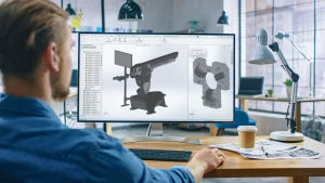 A man at a desktop designing using SOLIDWORKS Standard